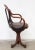 Swivel chair in steam-bent beech wood, Thonet style The circular seat rests on a three-legged cast iron base The fabric...