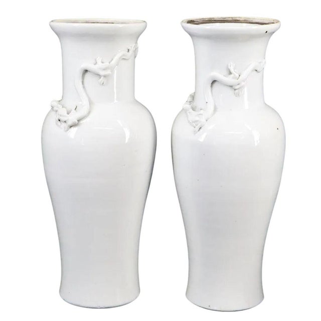Pair of blanc de chine Chinese vases with chinoiserie design dragon motif encircling the vase neck