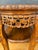 Chinese carved hardwood accent table, mid-20th century. The circular top rests above an intricately carved apron featuring...