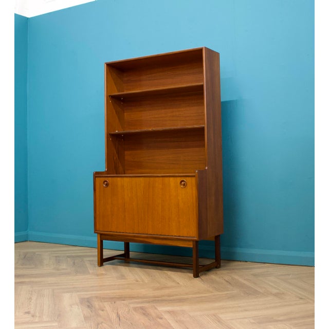 A mid century teak tall record cabinet or bookcase from Turnidge, circa 1960s Featuring two shelves and additional file or...
