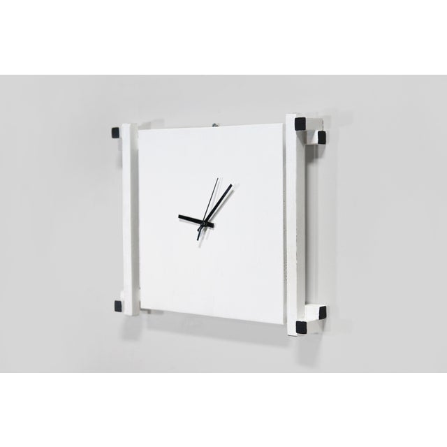 A beautiful white clock, made in the style of Gerrit Rietveld. In the 1980s, a book was published entitled "How to...