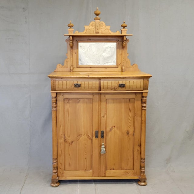 This stunning antique, circa 1880s, pine Swedish sideboard buffet is topped with a mirrored crown embellished with finials...