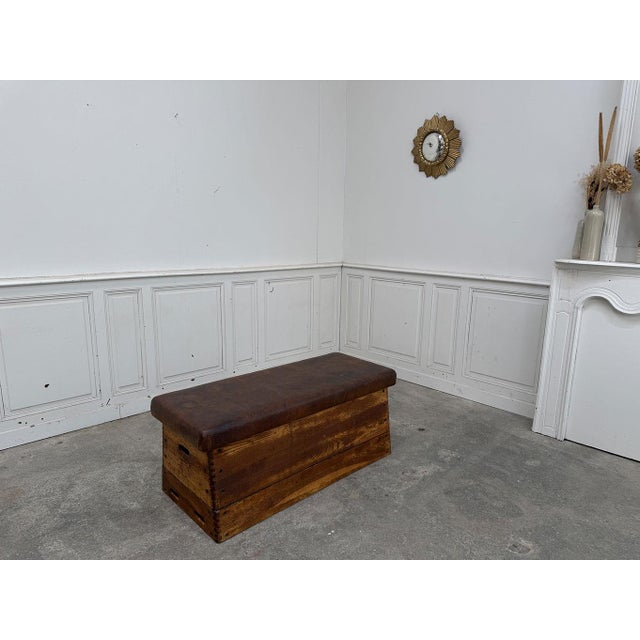 This vintage pommel horse from the 1950s, repurposed as a firm leather bench, features a solid wood base with a lovely...