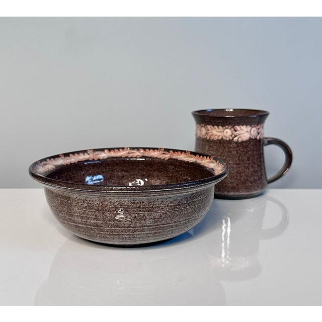 A high-quality set of two studio ceramic art vessels including a cup and a bowl, created by the renown ceramist duo Elli...