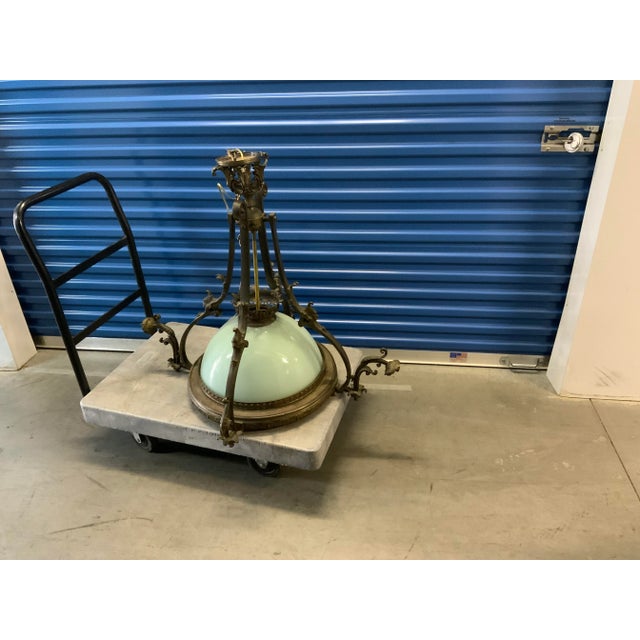 A very elegant antique chandelier the chandelier very old but still beautiful. Made of bronze and glass very unique piece....