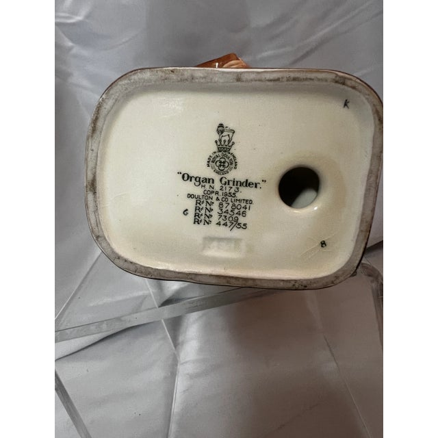 HN 2173 1955 Royal Doulton Organ Grinder figurine measures 9” tall. Excellent condition.