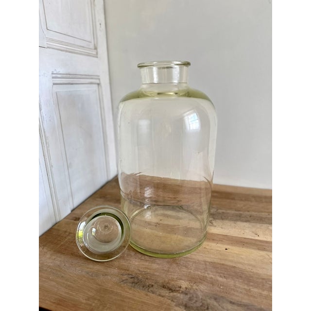 Large French laboratory storage jar in thick clear glass with a fitted glass stopper, dating to the early 20th century