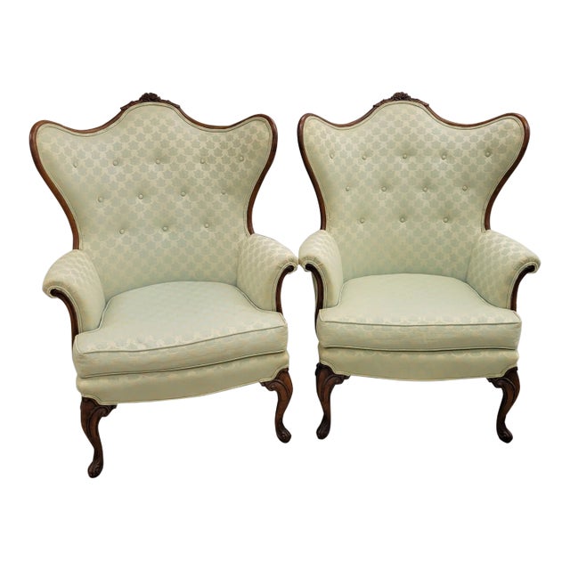 Pair of Mid-Century French Louis XV–Style Carved Walnut Wingback Chairs For Sale