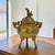 A mid-20th-century Japanese tripod incense burner, or kōro, cast in copper alloy and decorated with polychrome champlevé...