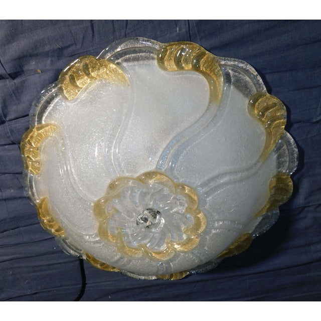 Italian flush mount with a clear and amber Murano glass diffuser hand blown in graniglia technique creating granular...