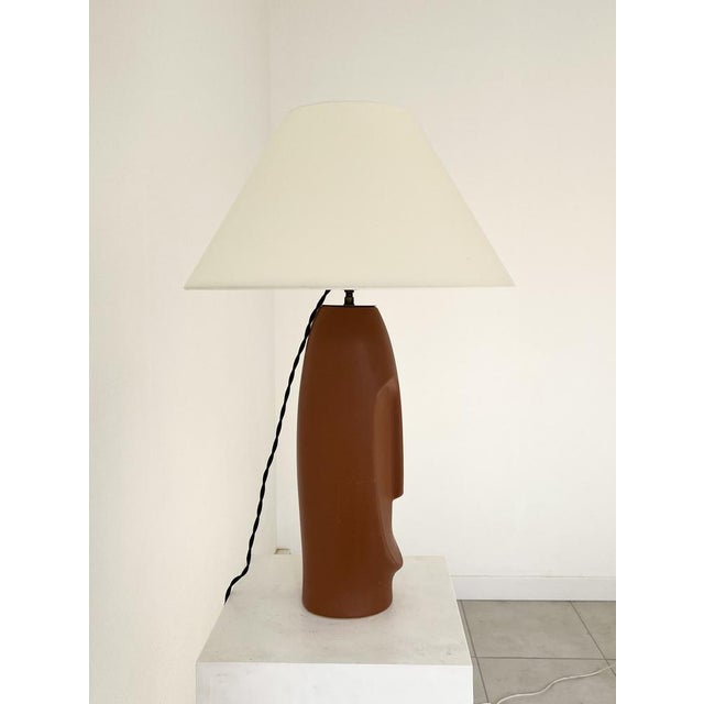 Glazed terracotta table lamp representing the face of a sculpture from Easter Island, France circa 1990 European Plug (up...