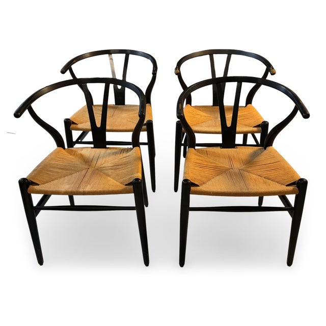 Set of four Wishbone dining chairs, attributed to Hans Wegner. Unmarked. Designed by Hans Wegner in 1949 and manufactured...