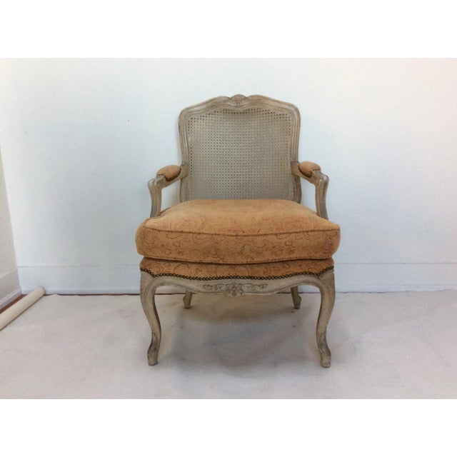 Nice cushion topped and caned back armchair with a painted finish.