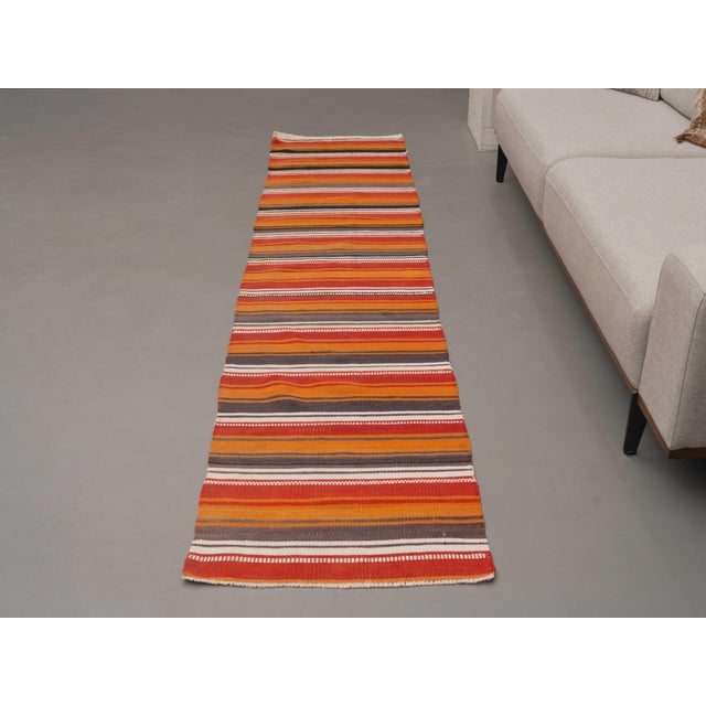 Vintage Hand-Knotted runner rug is a semi-antique vintage area rug. The '70s Eastern region of Anatolia's unique rug is...