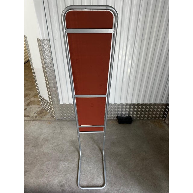Large modernist cheval mirror dating from the 1970s. The structure is made of bent gray tubular metal, forming both the...