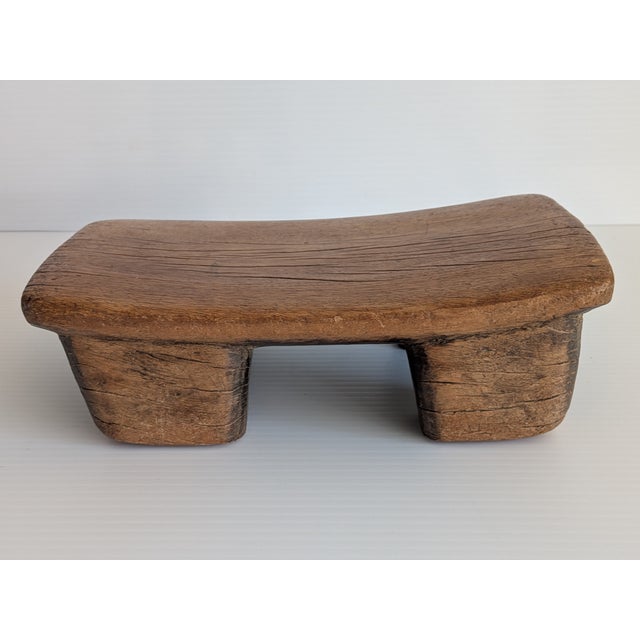 This early 1900s hand carved stool is carved from a single block of very dense wood. It is dangerous to carve these stools...