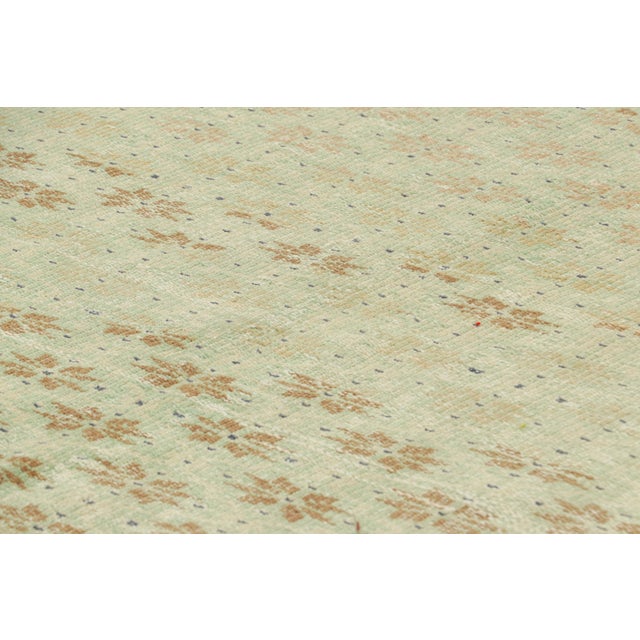 Hand-knotted in wool and originating from Turkey circa 1960 – 1970, this 5x9 vintage Zeki Müren rug is a unique addition...