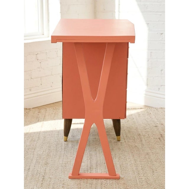 A playful vintage single pedestal desk finished in a warm peach tone. The streamlined rectangular work surface is...