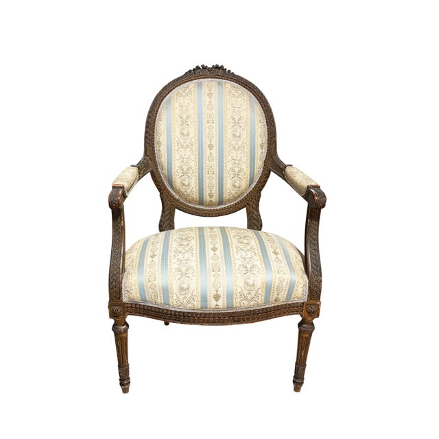 19th Century French Louis XVI walnut armchair ~ fauteuil is truly a timeless classic! Featuring curved oval seatbacks and...