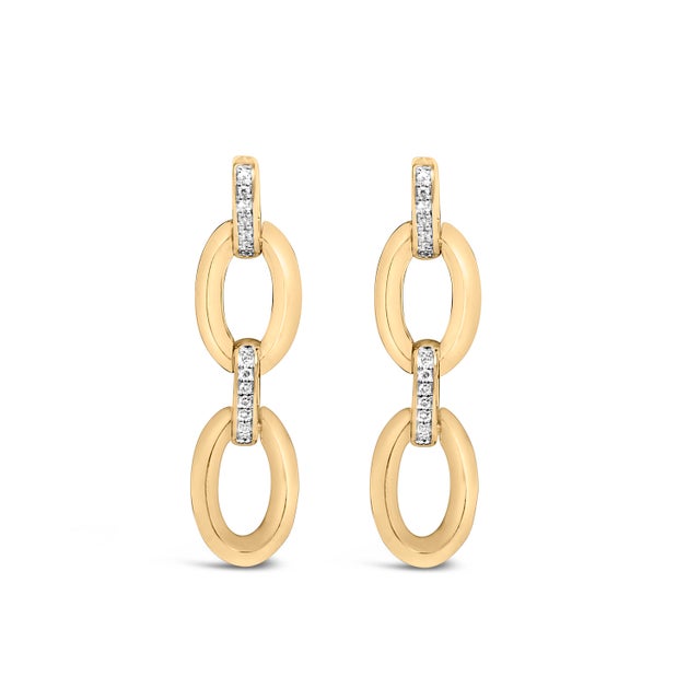 Glimmering with sculptural grace, these drop earrings trace a luminous ascent from a pavé-kissed slim connector to a bold...