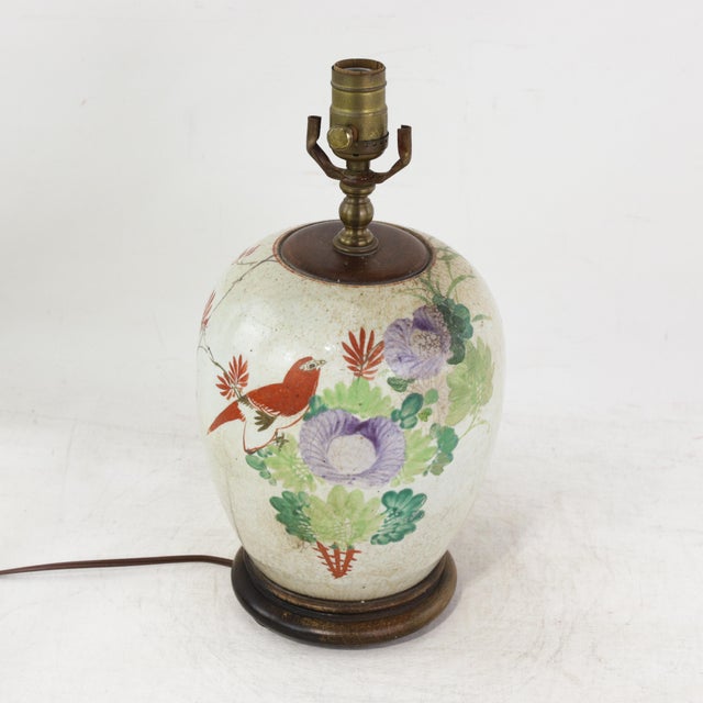 This antique table lamp is repurposed from an authentic white porcelain vase featuring a vibrant Famille Rose palette. The...