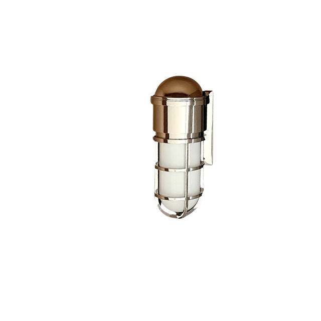 Visual Comfort Marine Caged Sconce by E. F. Chapman, model SL2000PN-WG, featuring a polished nickel finish and white glass...
