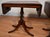 Description: Elegant pair of mid-20th century English Regency style Pembroke tables, crafted circa 1950 from rich,...