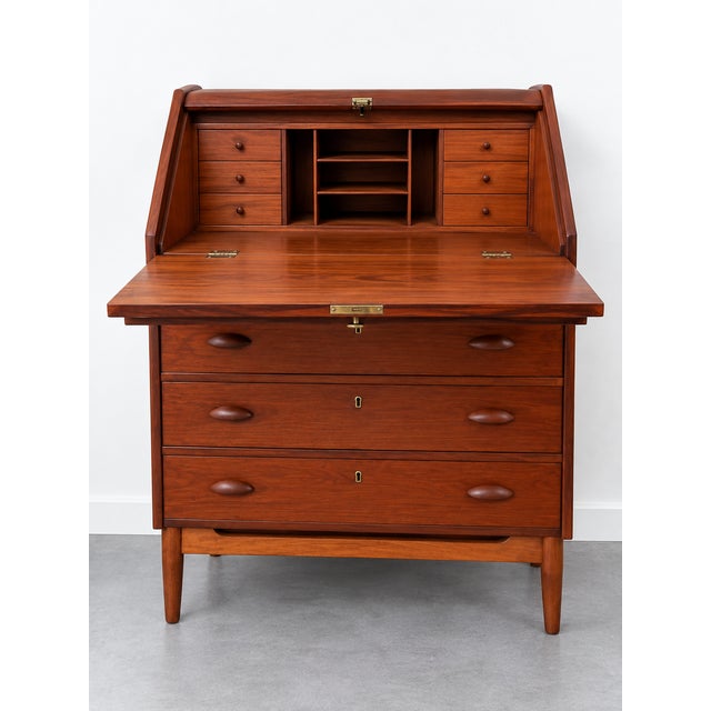 Elegant Danish Mid-Century Modern secretary desk dating from the 1960s, crafted in warm-toned wood and characterized by...
