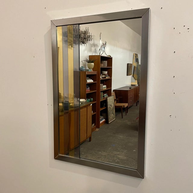 Mid Century Modern vintage Mirror in the style of Paul Evans The mirror is in vintage used condition. The mirror has...