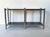 Unique 1970s vintage two-tier console table, entirely made of steel with double black glass shelves, featuring a sturdy...