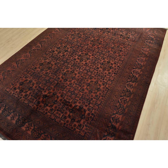 A tribal Turkmen rug hand-knotted with fine wool on a cotton foundation. This rug features rows of geometric medallions...
