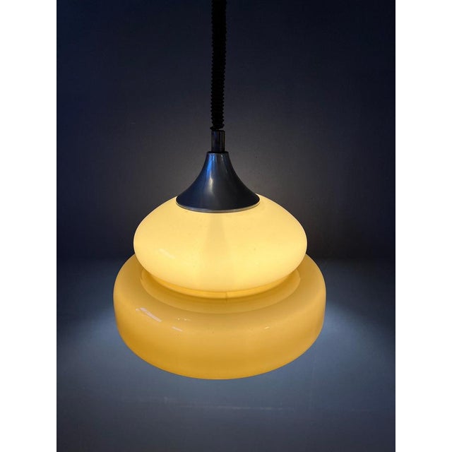 Mid century space age pendant light with a nicely shaped acrylic glass shade. The height of the lamp can easily be...