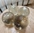 Decorative set of four handblown glass spheres in clear and smoky-gray tones. Each piece features subtle variations,...