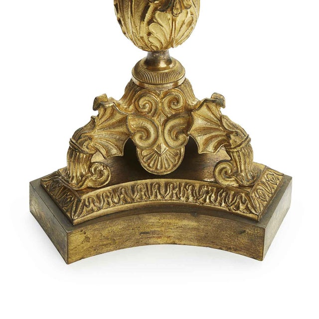 A pair of Empire three-light gilded bronze candelabra from the 19th century. They are in good condition, despite minor...