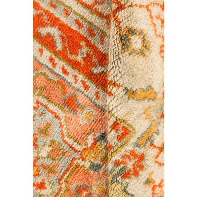 This stunning Antique Turkish Oushak rug, dating back to circa 1900, is a vibrant testament to the artistic legacy of...