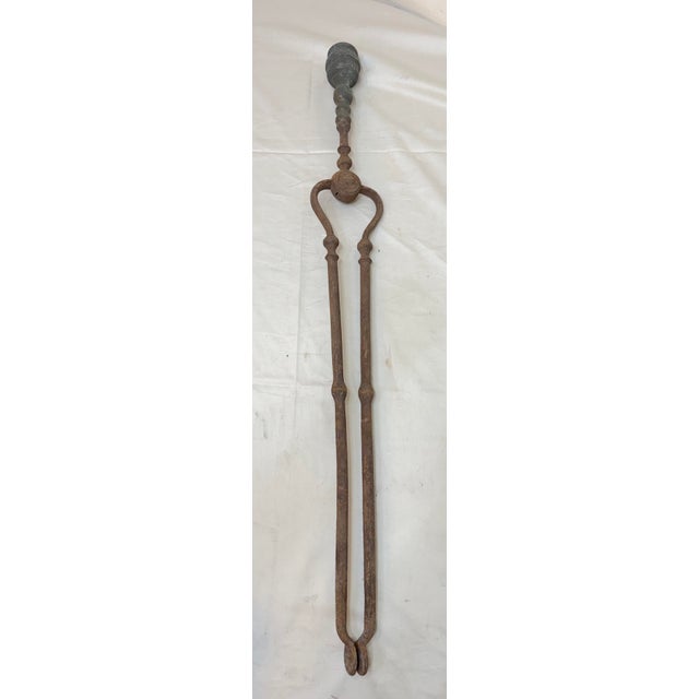 Up for sale is a large pair of rare antique 18th century wrought iron and brass English fireplace tongs. The arms are...