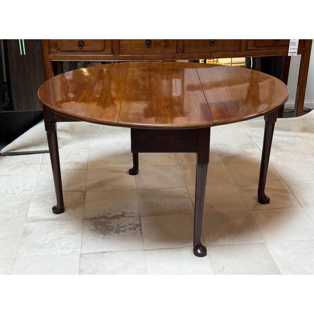 Design Plus Gallery presents a Drop Leaf or Pembroke Table in the George III Style. The table is made out of pure mahogany...