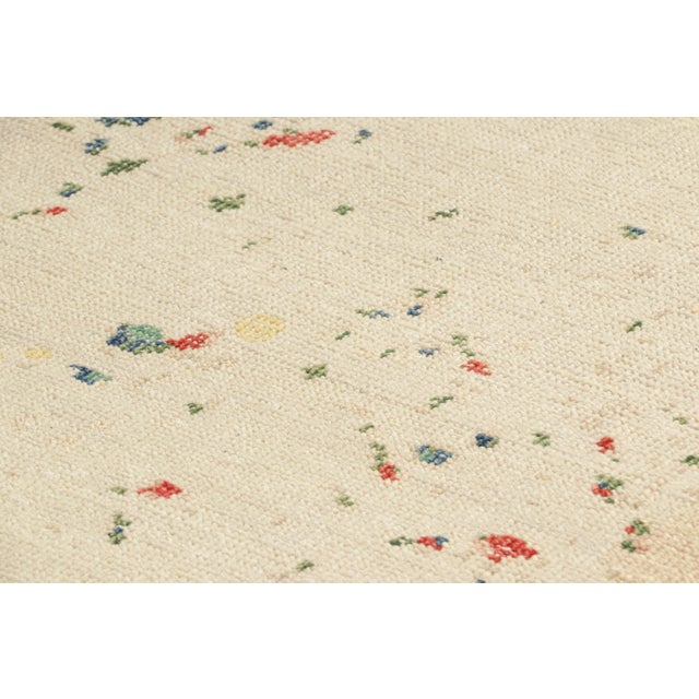 Hand-knotted in wool, this 3x5 modern rug, originating from India, as inspired by modern art with an abstract pattern, is...