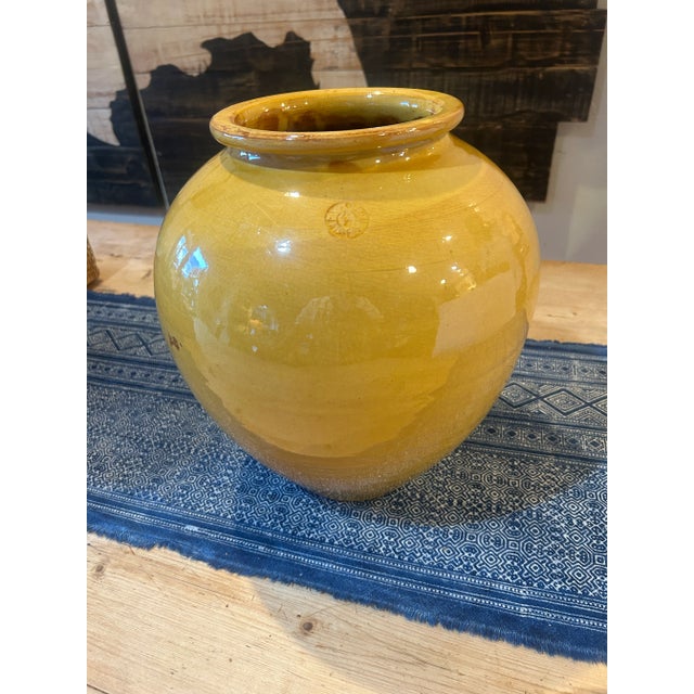 A beautifully aged French terracotta jar with a rich mustard glaze, made in Vallauris, France. This traditional confit or...