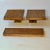 Two square cast bronze door handle with matching letterbox fine lineair textural surface like straw. They have a golden...