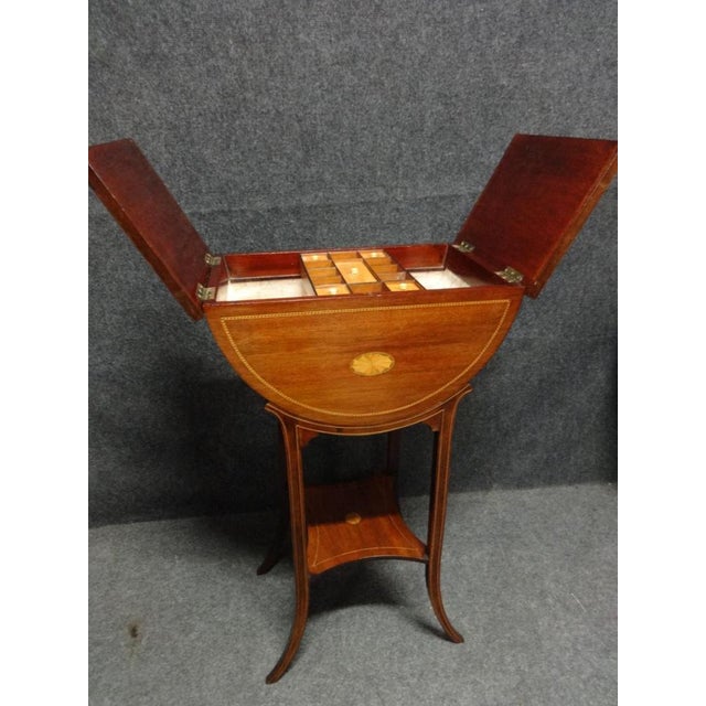 This is a very pretty Edwardian antique mahogany inlaid sewing box with lift up lid and sliding tray, in very good...