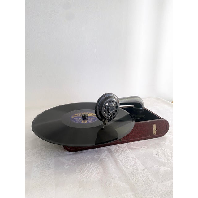 Antique Thorens Excelda portable gramophone, manufactured in Switzerland in the 1930s. Presented in a red enamelled metal...