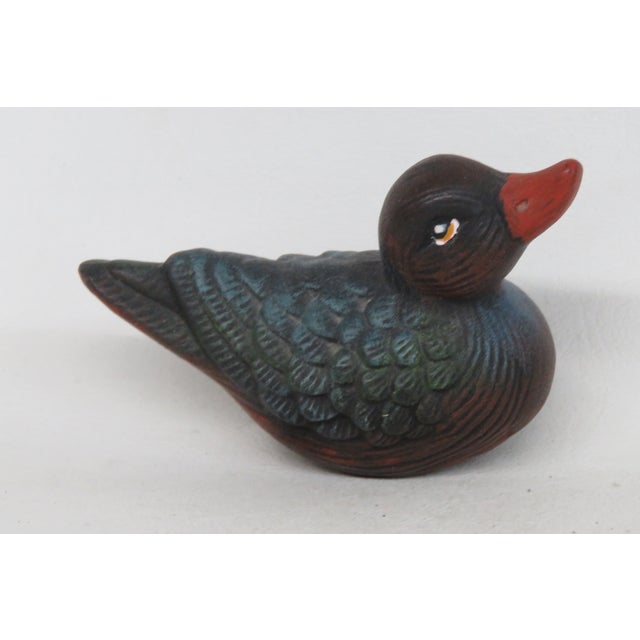This highly charming Miniature Duck Figurine is made of ceramic. This darling duck presents a feathered colorway of blue...