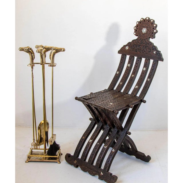 A sophisticated vintage French solid brass fireplace tool set, circa 1940s, distinguished by four beautifully modeled...