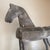 Rustic, primitive folk-art style carved wood horse sculpture featuring a weathered, distressed finish mounted on a black...