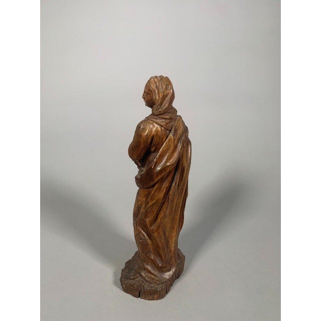 16th-century walnut wood sculpture of the Virgin and Child. Depicts the Virgin Mary holding the infant Jesus in her arms....