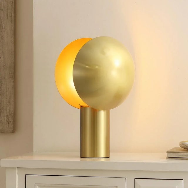 Illuminate your space with the Frey table lamp, a stunning 15 inch piece crafted from brass metal. This lamp is the...