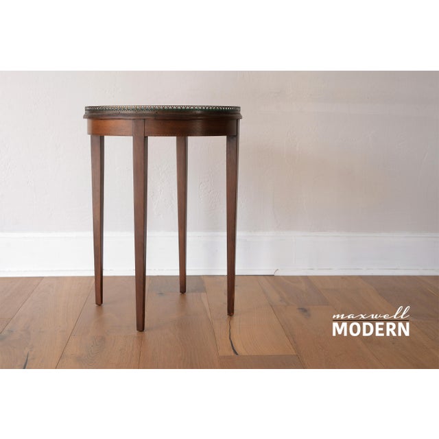 Gorgeous mid century era French style bouillotte round side table with glass top. Impeccable details on the pierced brass...