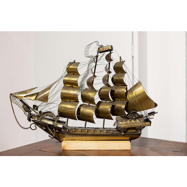 An Italian brass Venetian model ship from the 20th century with four masts, mounted on wood. This exquisite Italian brass...