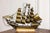 An Italian brass Venetian model ship from the 20th century with four masts, mounted on wood. This exquisite Italian brass...